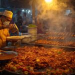 Chefs cooking sizzling meat and kebabs at a busy best Lahore food street